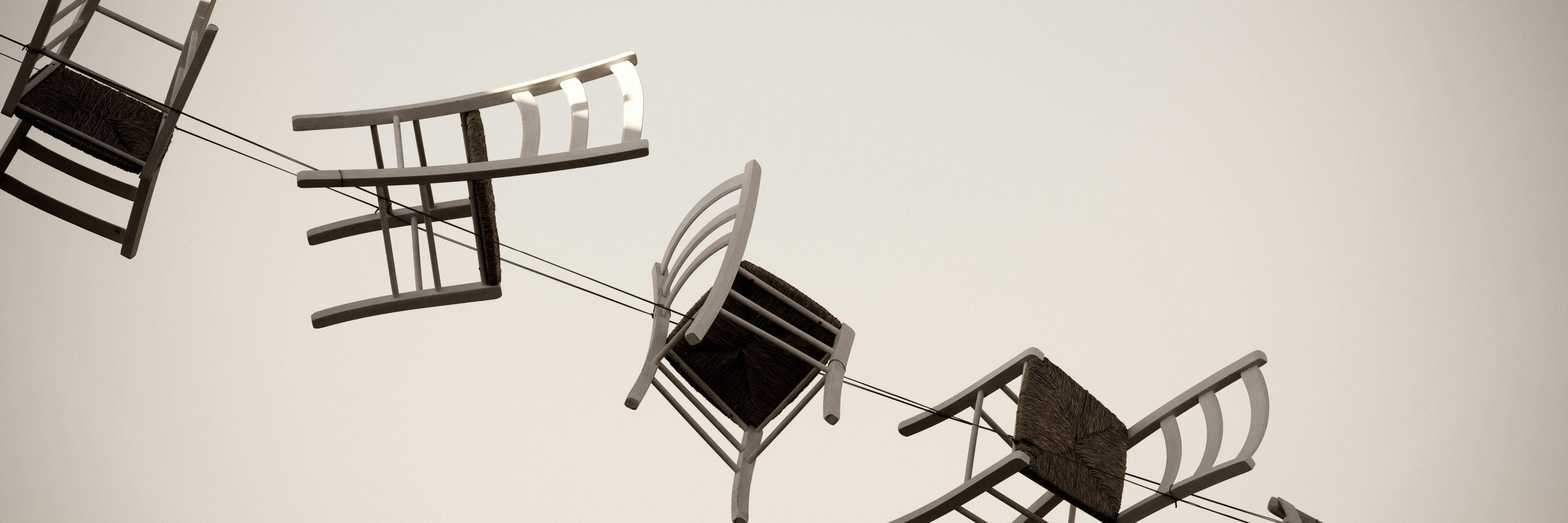 4 floating chairs tethered by a rope.