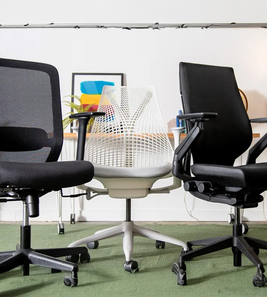 Three chairs—two black swivel chairs with one white swivel chair in the middle.