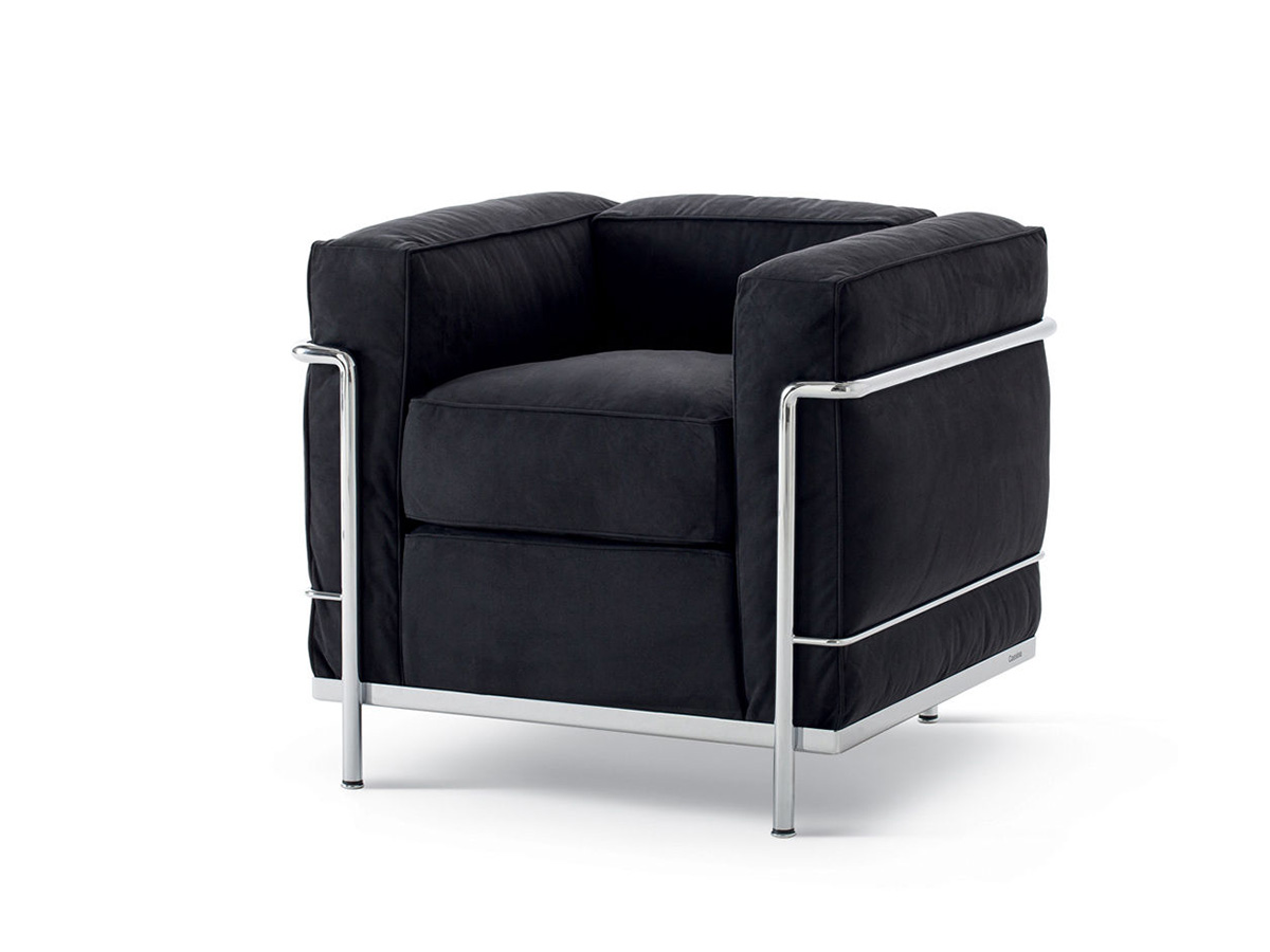 Black square chair with square armrests and silver metal legs and bars.